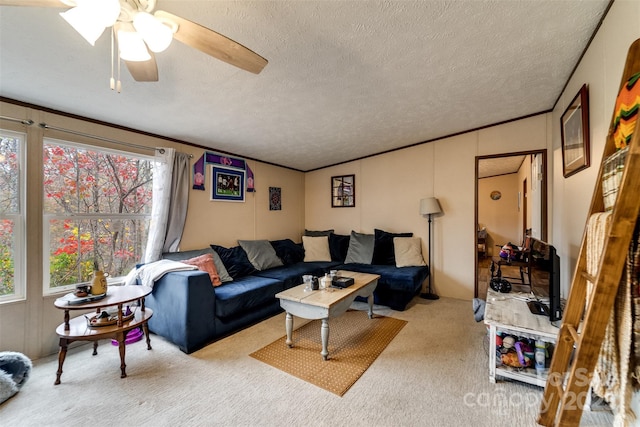 carpeted living room featuring a textured ceiling, ceiling fan, and ornamental molding