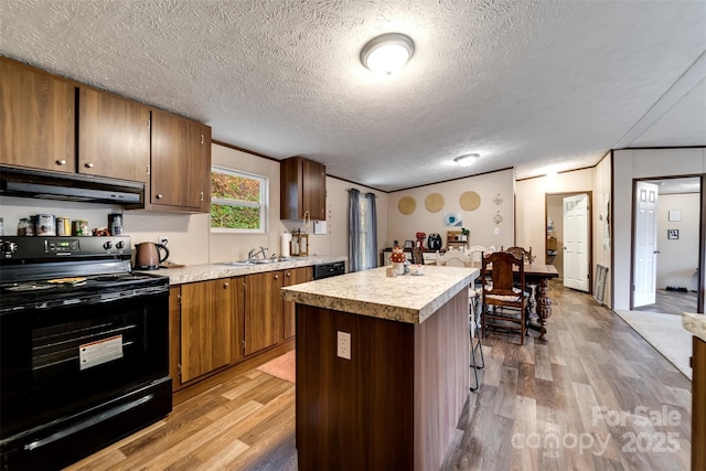 kitchen featuring a textured ceiling, sink, black appliances, light hardwood / wood-style floors, and a kitchen island