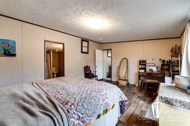 bedroom featuring a textured ceiling, ensuite bathroom, wood-type flooring, and crown molding