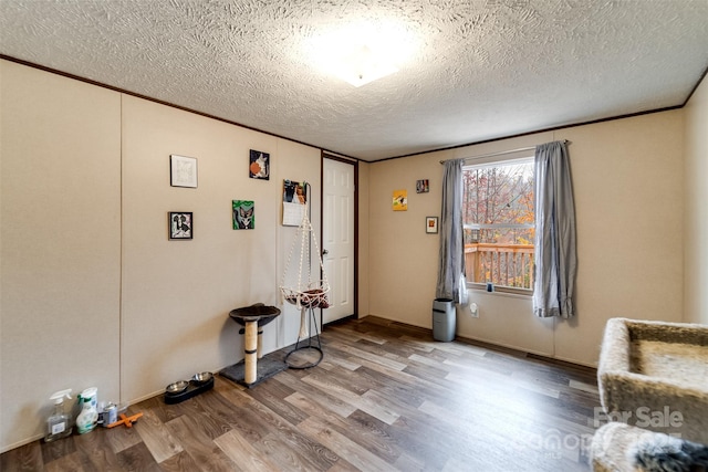 entrance foyer with wood-type flooring and a textured ceiling