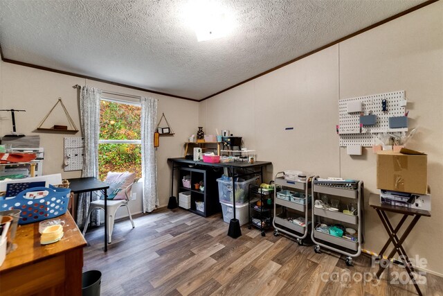 home office with wood-type flooring, a textured ceiling, and ornamental molding