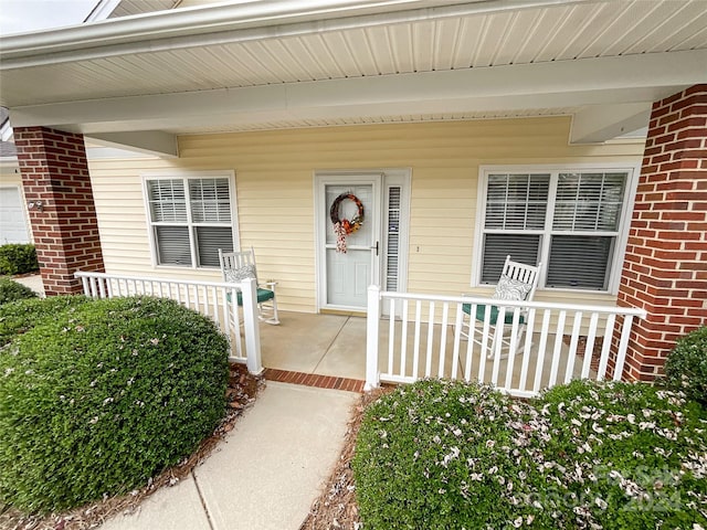 entrance to property featuring a porch