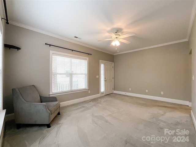 unfurnished room featuring ornamental molding, light colored carpet, and ceiling fan