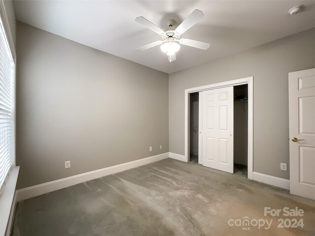 unfurnished bedroom featuring ceiling fan, light carpet, and a closet