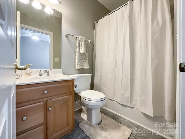 full bathroom with ceiling fan, vanity, toilet, and shower / bath combination with curtain