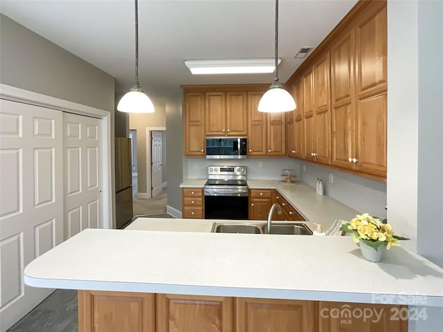 kitchen featuring kitchen peninsula, stainless steel appliances, hanging light fixtures, and sink