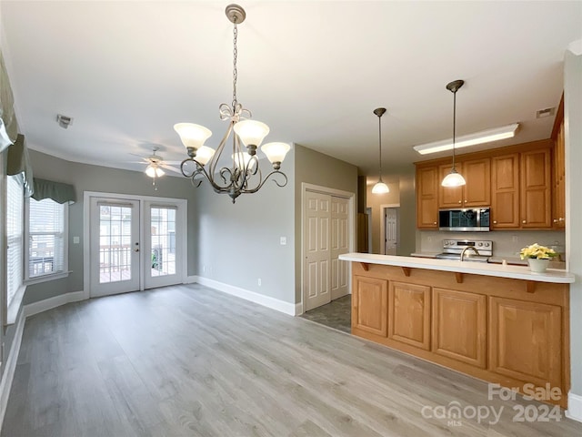 kitchen featuring french doors, light hardwood / wood-style floors, ceiling fan with notable chandelier, appliances with stainless steel finishes, and decorative light fixtures