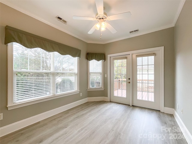 doorway with crown molding, french doors, ceiling fan, and light wood-type flooring