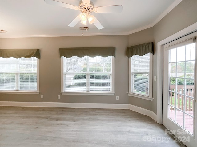 unfurnished dining area with ceiling fan, light hardwood / wood-style flooring, and crown molding