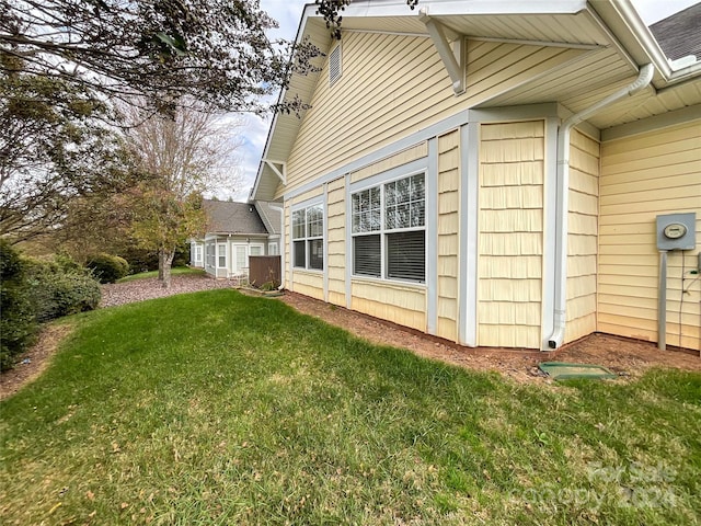 view of property exterior featuring a lawn