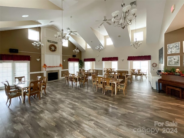 dining space with ceiling fan, dark hardwood / wood-style floors, and high vaulted ceiling