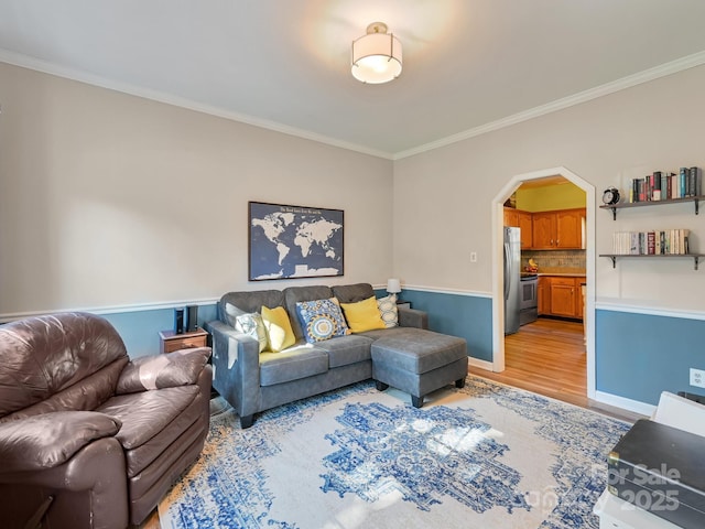 living room featuring crown molding and light hardwood / wood-style flooring