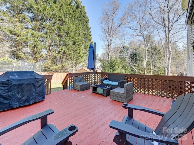 wooden deck featuring an outdoor hangout area and area for grilling