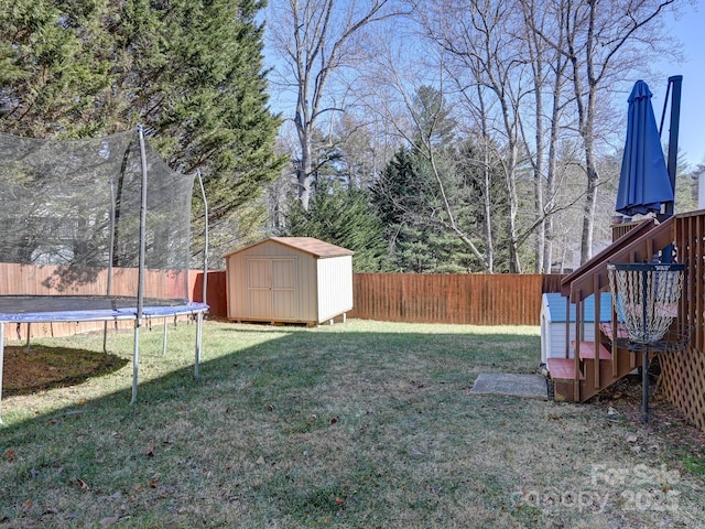 view of yard featuring a storage unit and a trampoline