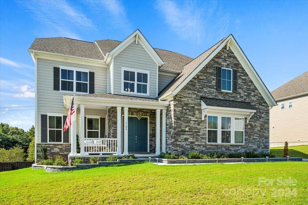 craftsman-style house featuring a porch and a front yard