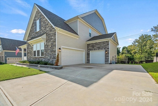 view of side of property with a garage and a yard