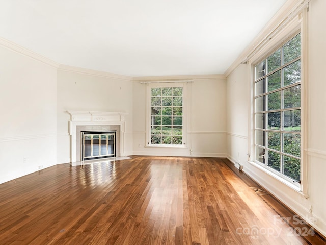 unfurnished living room with hardwood / wood-style flooring and ornamental molding