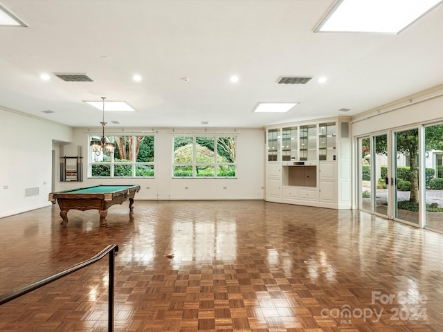 playroom with dark parquet floors, crown molding, and billiards