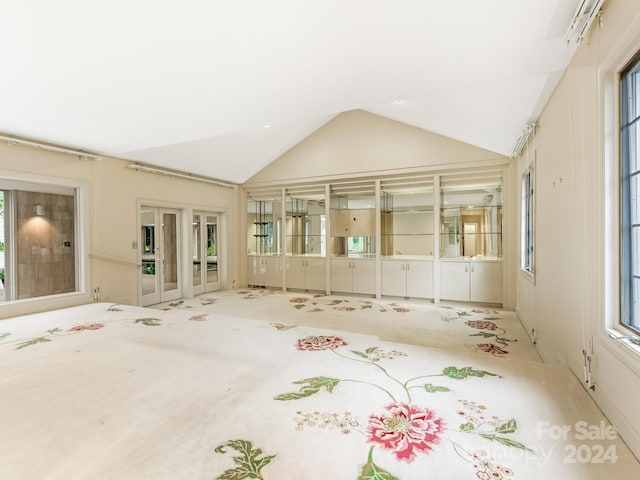 unfurnished sunroom featuring french doors and vaulted ceiling