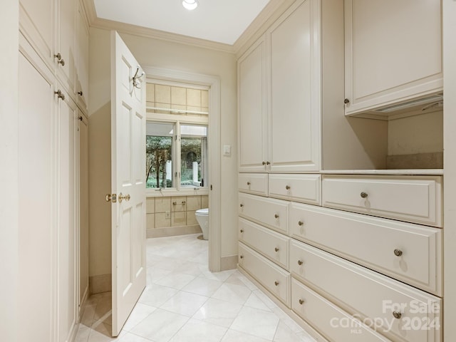 spacious closet with light tile patterned floors