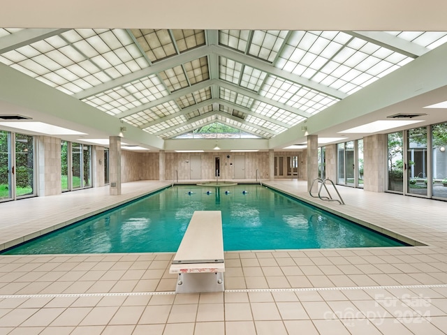 view of swimming pool with a diving board