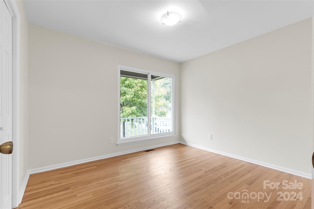 unfurnished room with light wood-type flooring