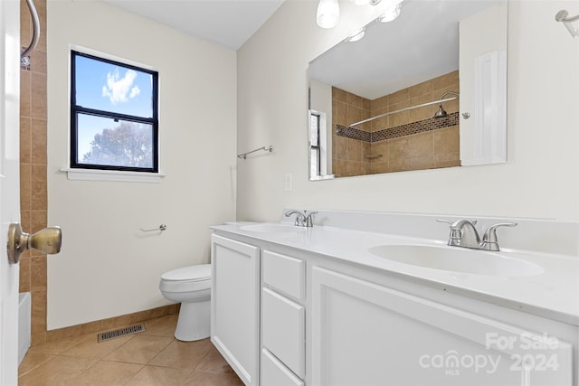 bathroom featuring toilet, vanity, and tile patterned floors