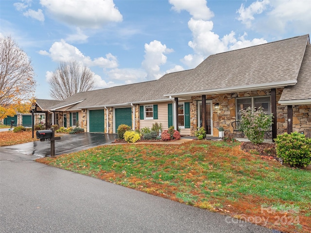 ranch-style house with a garage and a front lawn