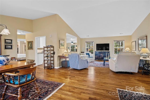 living room featuring high vaulted ceiling, hardwood / wood-style flooring, and ceiling fan