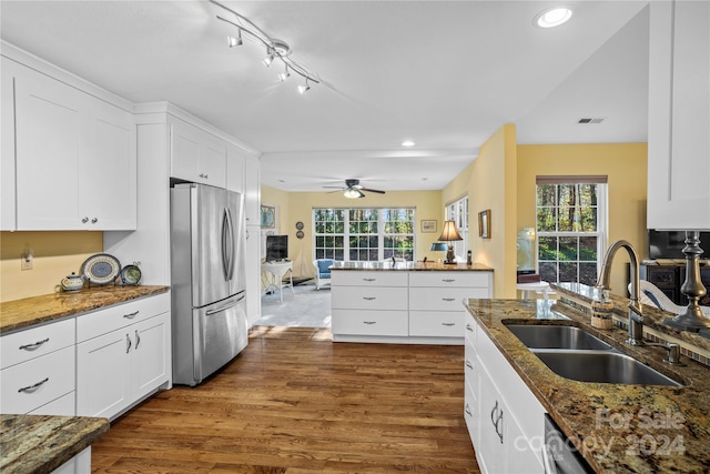 kitchen featuring dark hardwood / wood-style flooring, white cabinetry, sink, and stainless steel fridge