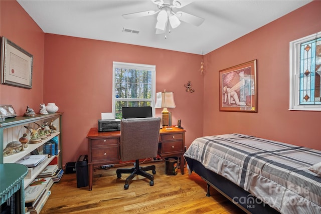 bedroom with wood-type flooring and ceiling fan