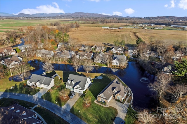 birds eye view of property with a water and mountain view