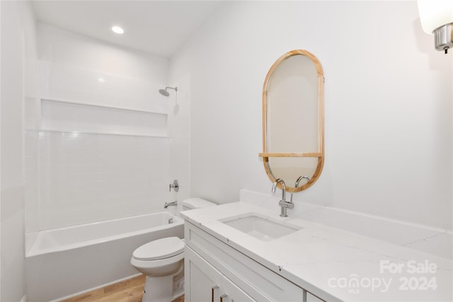 full bathroom featuring toilet, vanity, bathtub / shower combination, and hardwood / wood-style flooring