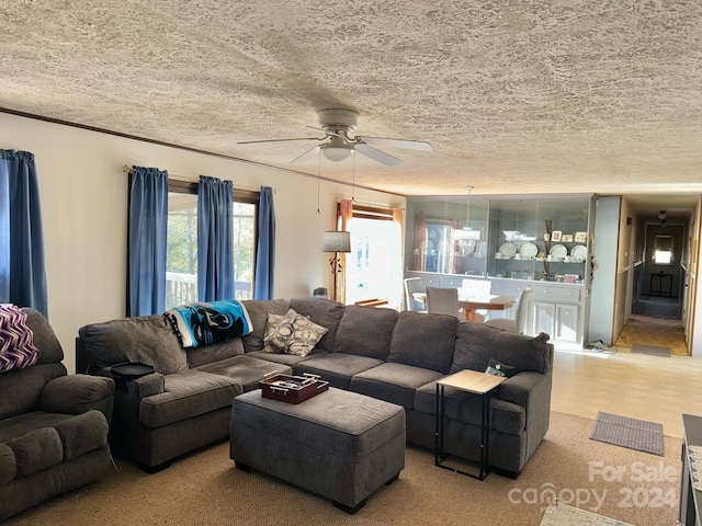 living room with a textured ceiling and ceiling fan