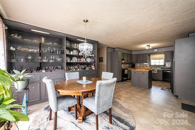 dining space with a textured ceiling and sink