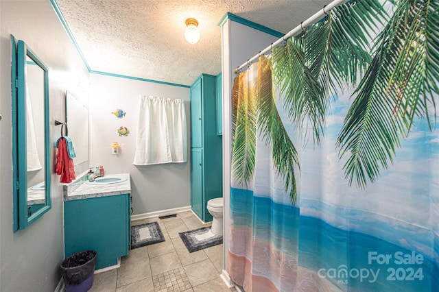 bathroom with tile patterned floors, toilet, a textured ceiling, ornamental molding, and vanity