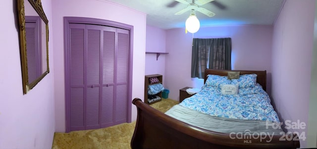 carpeted bedroom with a closet and ceiling fan