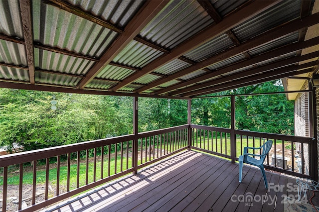 wooden terrace with a lawn