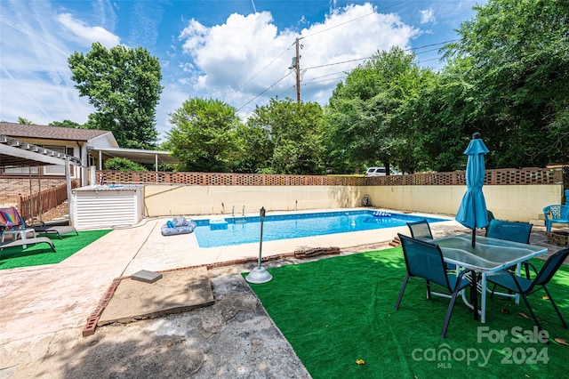 view of swimming pool with a patio