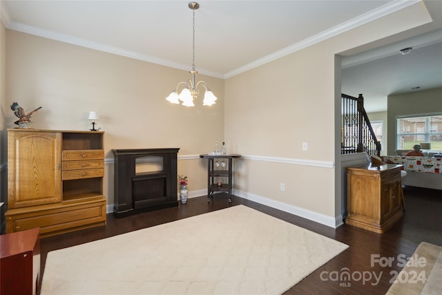 interior space with ornamental molding, an inviting chandelier, and dark hardwood / wood-style floors