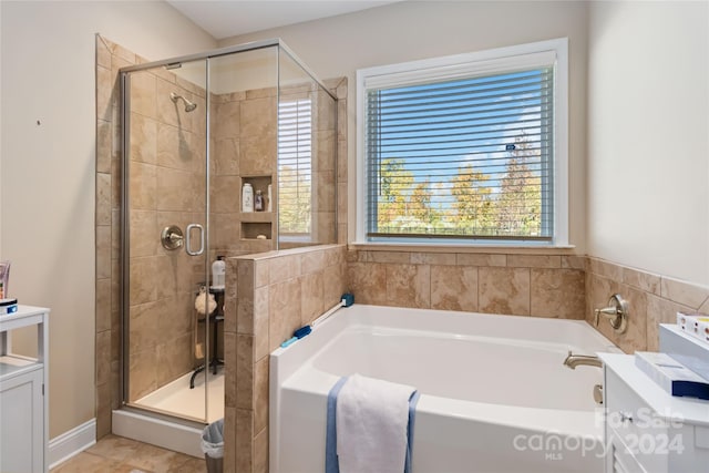 bathroom featuring separate shower and tub