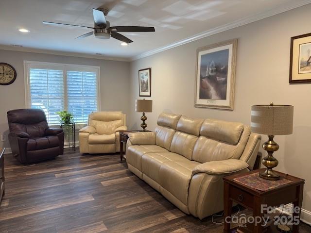 living room with ceiling fan, crown molding, and dark hardwood / wood-style floors