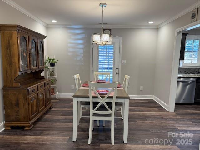 dining space with a notable chandelier, plenty of natural light, and dark hardwood / wood-style floors