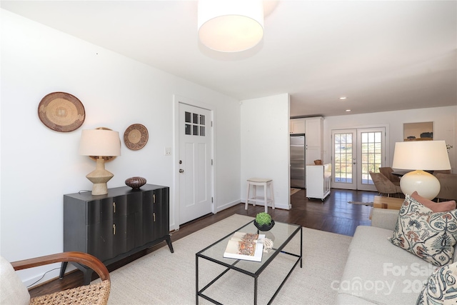 living room featuring recessed lighting, french doors, baseboards, and wood finished floors