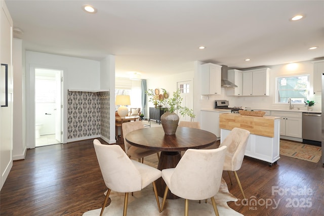 dining room with recessed lighting and dark wood finished floors