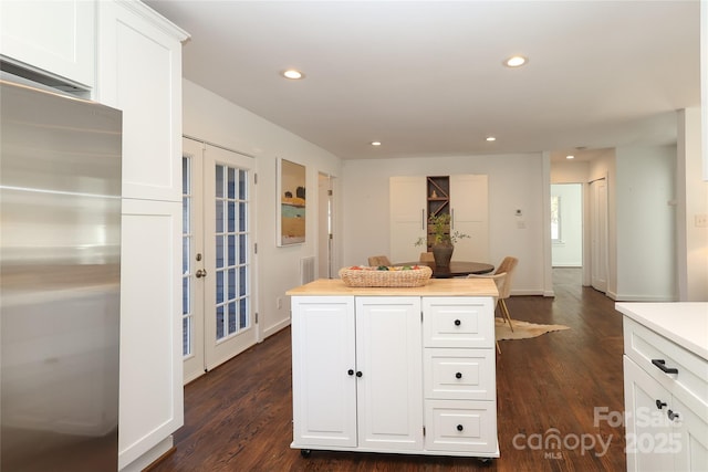 kitchen featuring recessed lighting, stainless steel fridge, white cabinets, and french doors