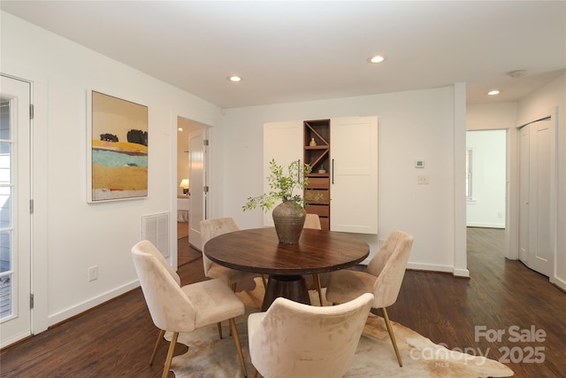 dining space featuring dark wood-type flooring, recessed lighting, visible vents, and baseboards