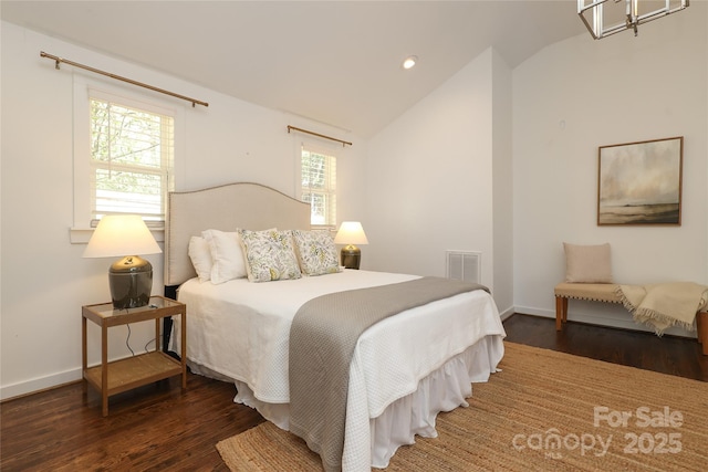 bedroom featuring vaulted ceiling, dark wood-style floors, visible vents, and baseboards