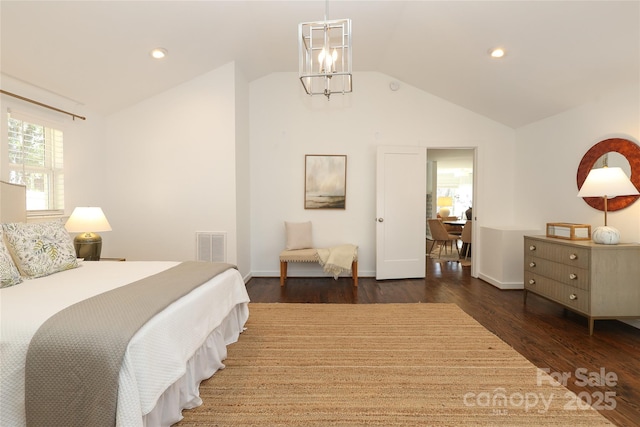 bedroom with dark wood-type flooring, lofted ceiling, visible vents, and an inviting chandelier