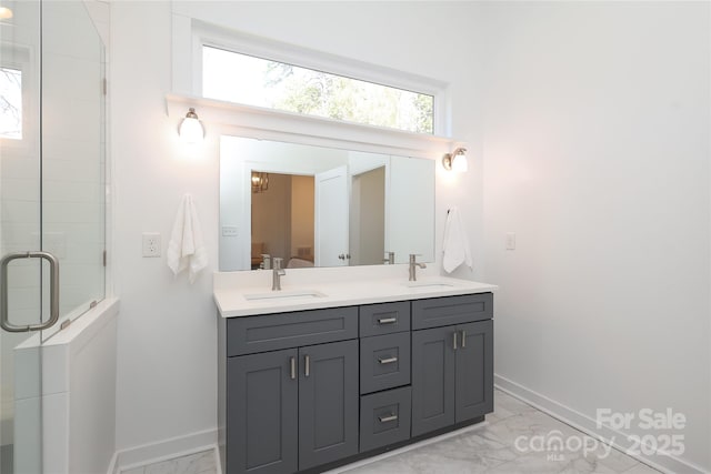 full bathroom with marble finish floor, a shower stall, connected bathroom, and a sink